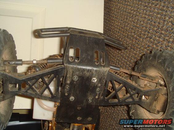 Chassis of a remote control car showing suspension and drive components