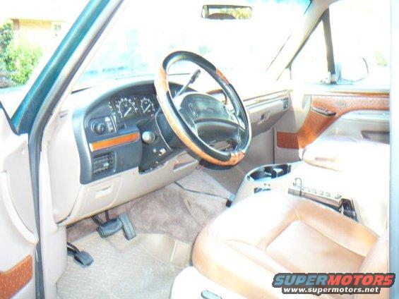 1992 Ford Bronco interior with tan leather seats and wood trim dashboard