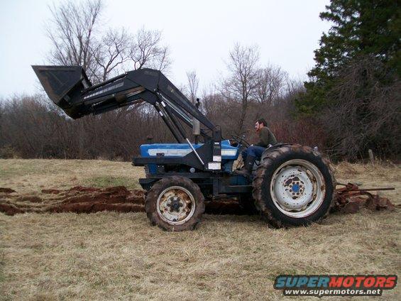 Tractor side view with front loader raised