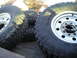1997 Ford F-250 - Close-up view of several large tires and their rims, likely for an off-road vehicle.