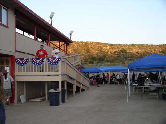 Outdoor event with tents and bleachers