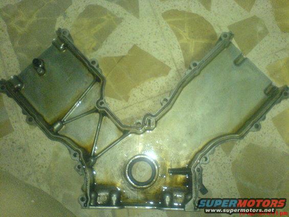 Engine timing cover with oil residue