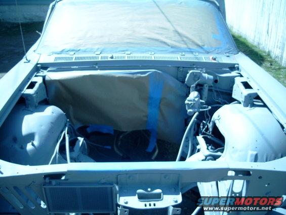1967 Ford Galaxie engine bay covered in masking paper and tape