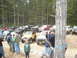 1989 Ford Bronco - A collection of off-road vehicles, including a 1989 Ford Bronco, are gathered in a wooded area.