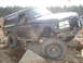 1989 Ford Bronco - Ford Bronco tackling a challenging off-road course with large rocks.