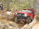 1989 Ford Bronco - This red 1989 Ford Bronco navigates a rocky trail with a winch and snorkel attached.