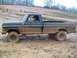 1979 Ford F-250 - This pickup truck is navigating a muddy off-road course with spectators in the background.