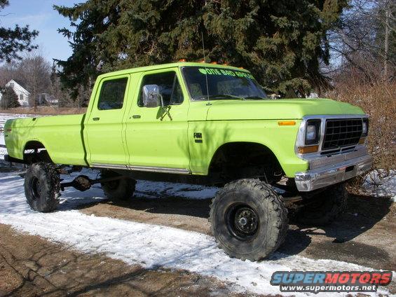 Lime green crew cab pickup truck with large tires and "ONE BAD APPLE" sticker on windshield