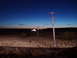 2009 Kenworth T800 - Dusk scene with a utility pole and distant lights on the horizon.