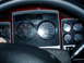 2009 Kenworth T800 - The interior of a truck shows a dashboard with multiple gauges and a digital display.