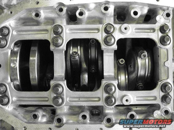 Engine crankshaft and connecting rods with bearing caps. Supermotors.net logo visible