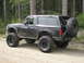 1979 Ford Bronco - This modified SUV, likely a 1992-1996 Ford Bronco, is equipped for off-road use.