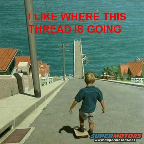 Child on skateboard on a steep hill overlooking the ocean with houses on the side