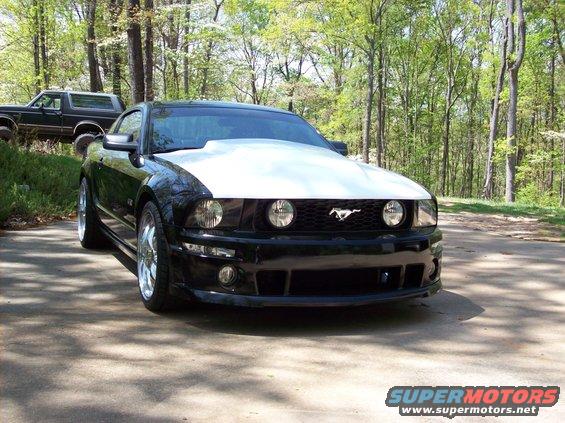 Black 2007 Ford Mustang with a white hood and chrome wheels