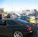 1995 Ford Probe - A black 1995 Ford Probe is parked at an outdoor car show with several other vehicles in the background.