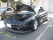 1995 Ford Probe - A black Ford Probe is parked with its hood open, revealing the engine compartment.