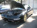 1995 Ford Probe - A black Ford Probe is parked outside with its hood open, showing the engine compartment.