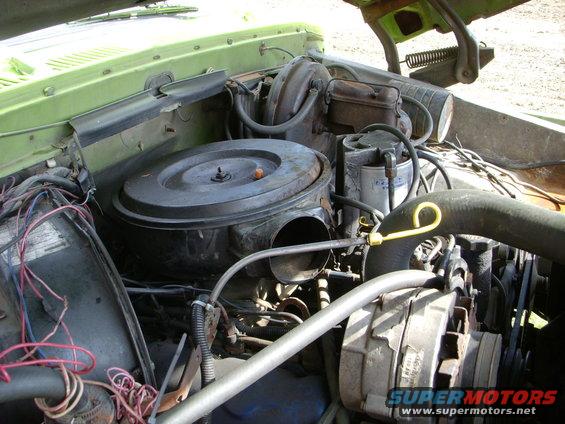 Engine bay with air cleaner, brake booster, and alternator visible