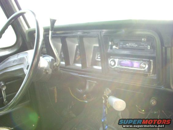 1974 Ford F-350 interior showing steering wheel, dashboard, and aftermarket radio