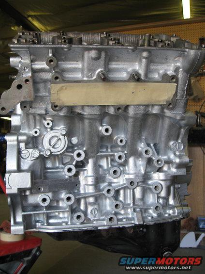 Engine block with various ports and a taped-off section. Some text is visible on the side