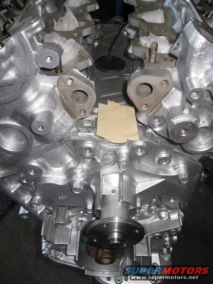 Engine block with silver finish and visible bolts