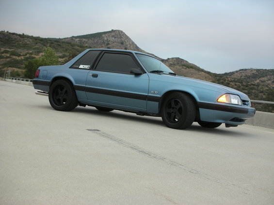 Blue 1990 Ford Mustang 3q-front view with black trim and wheels
