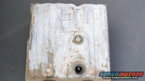 Metal fuel tank with USS Long Termies marking, showing rust and wear
