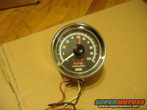 Tachometer with chrome bezel, black face, red needle, and RPM markings