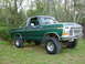 1979 Ford F-150 - This lifted 1979 Ford F-150 pickup truck is shown in a three-quarter front view, parked outdoors on a grassy area.