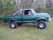 1979 Ford F-150 - Side view of a lifted 1979 Ford F-150 pickup truck with a roll bar.