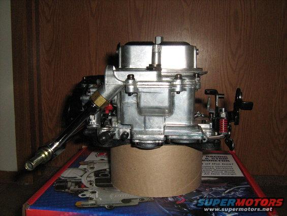 Holley carburetor on top of a box with SuperMotors.net logo