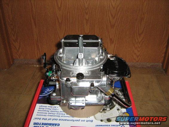Holley carburetor sitting on a box with text about performance and carburetors