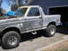 1987 Ford Bronco - This SUV is undergoing bodywork and is shown in primer with aftermarket wheels and step bars.