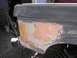 1987 Ford Bronco - The rear fender of a vehicle is covered in body filler and primer, indicating repair work is in progress.