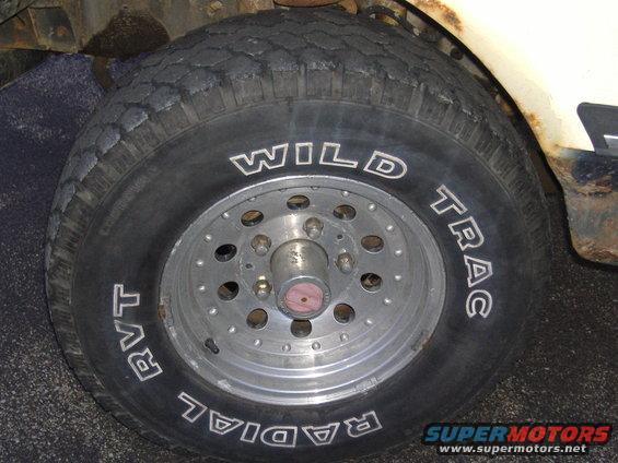 Close-up of a tire with "WILD TRAC RADIAL RVT" text and a multi-hole alloy wheel