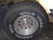 1988 Ford Bronco - Tire and wheel detail from an older vehicle, showing "WILD TRAC RADIAL RVT" branding.