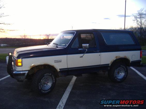 Two-tone Ford Bronco parked outside at dusk