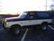 1988 Ford Bronco - This two-tone Ford Bronco shows rust on the rear fender, indicating its age.