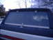 1988 Ford Bronco - The rear of a Ford Bronco, viewed from behind, displays its window and a portion of its body.
