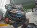 1982 Ford Bronco - This is a close-up shot of a greasy engine being hoisted, likely for repair or replacement.