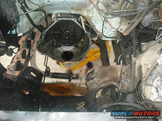 Transmission bell housing removed, showing torque converter and engine block
