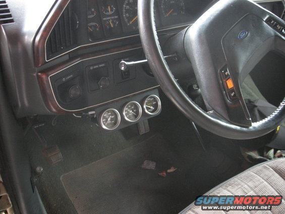 1990 Ford F-150 interior with three gauges below the dashboard