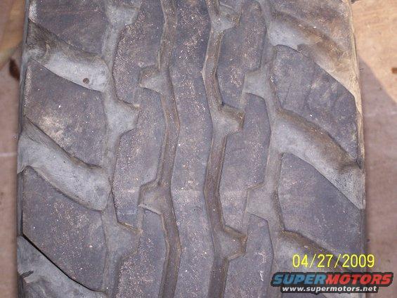 Close-up of a worn tire tread with visible date stamp