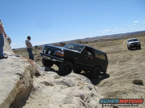 Black 1993 Ford Bronco navigating rocky terrain