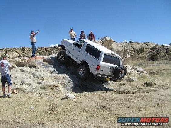 White 1993 Ford Bronco climbing rocky terrain