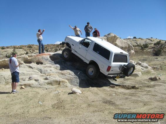 1993 Ford Bronco climbing rocks with people watching
