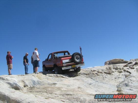Orange 1993 Ford Bronco on rocky terrain