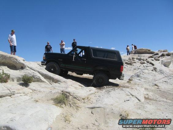 Black 1993 Ford Bronco climbing rocks