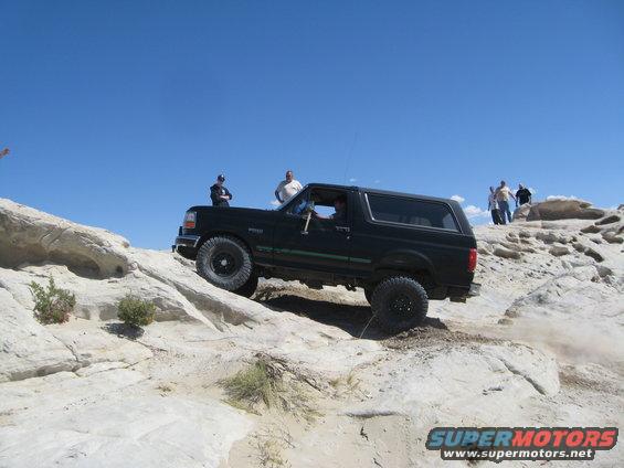Black 1993 Ford Bronco navigating rocky off-road trail