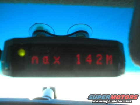 Radar detector display showing 'max 142M' with a yellow indicator light